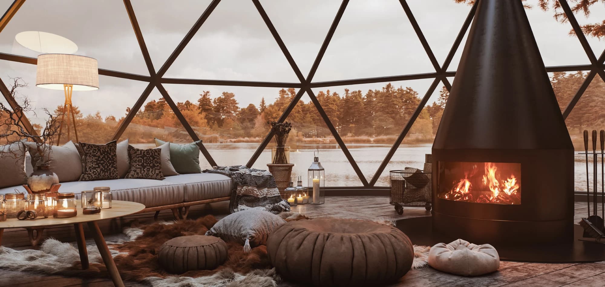 Inside a glass geodesic glamping dome with a fireplace and lake view
