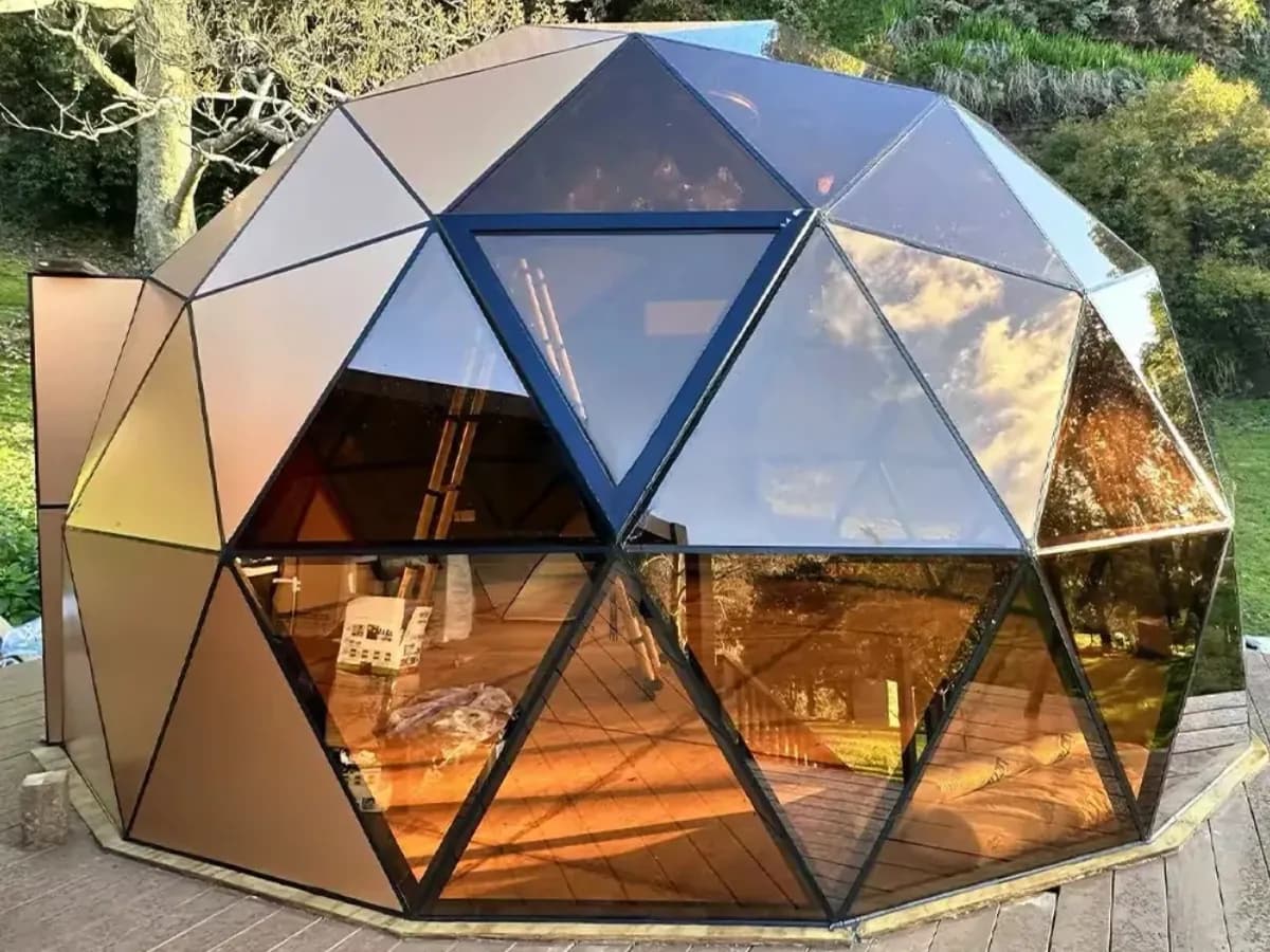 Hybrid geodesic dome house kit with glass and insulated panels. Perfect for glamping, Airbnb, or eco-resorts. Built to last by The Dome House.