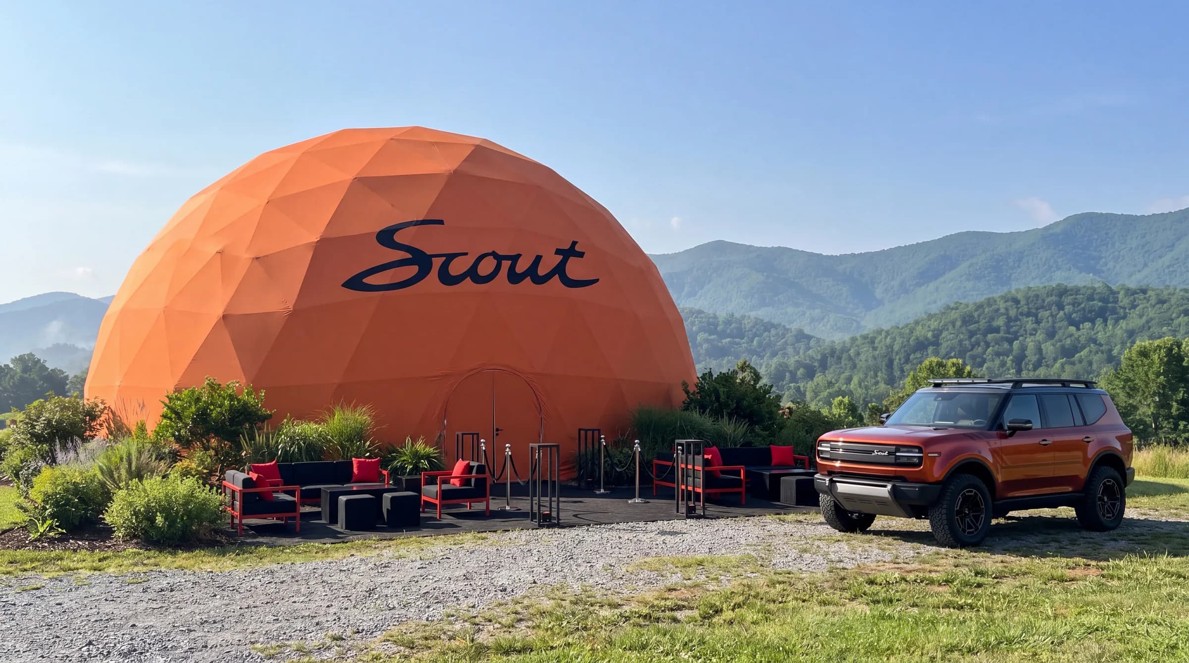 Branded geodesic event dome at a Scout Motors activation with visitors outside
