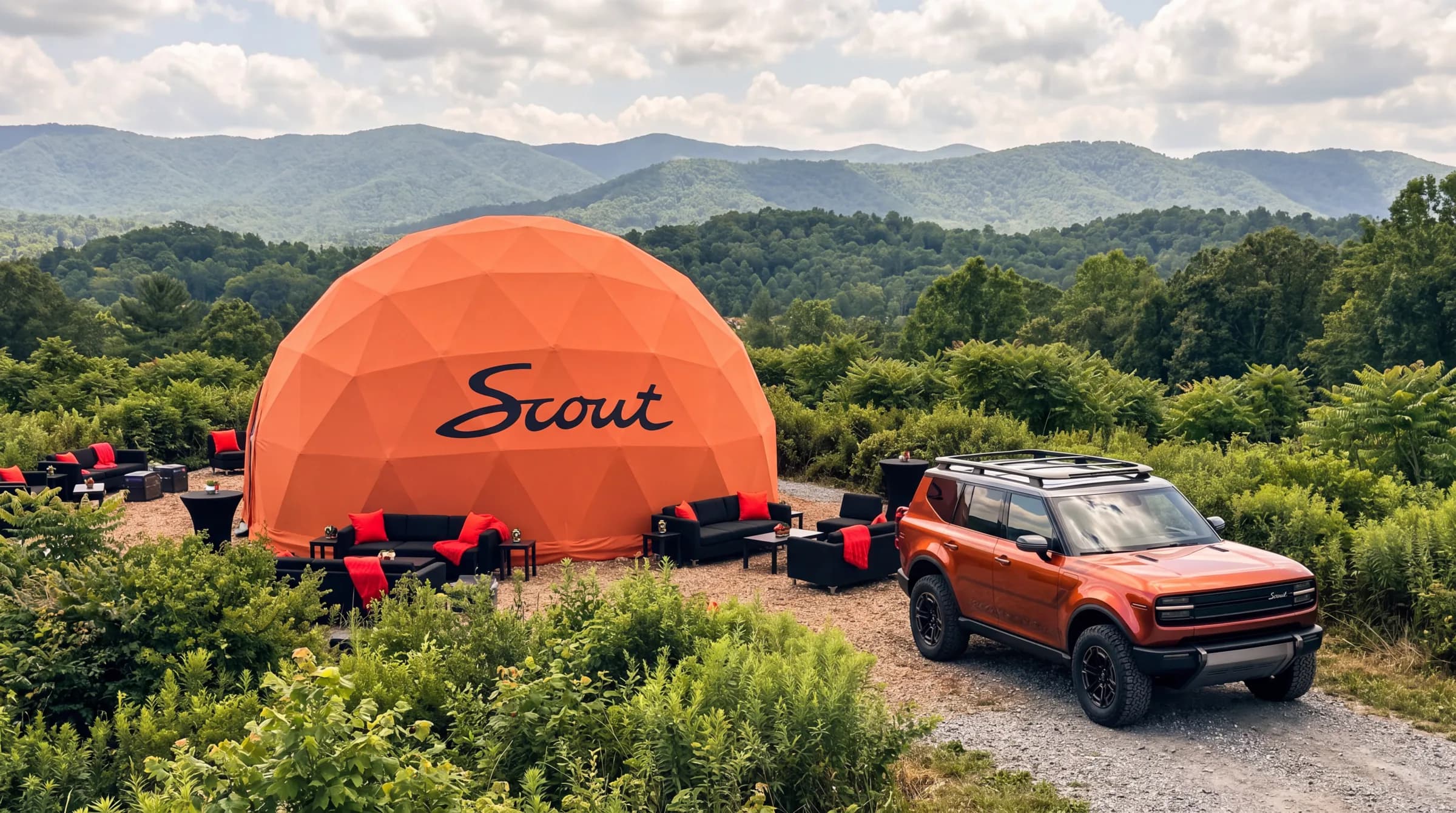 Branded geodesic event dome at a Scout Motors activation with a vehicle on display