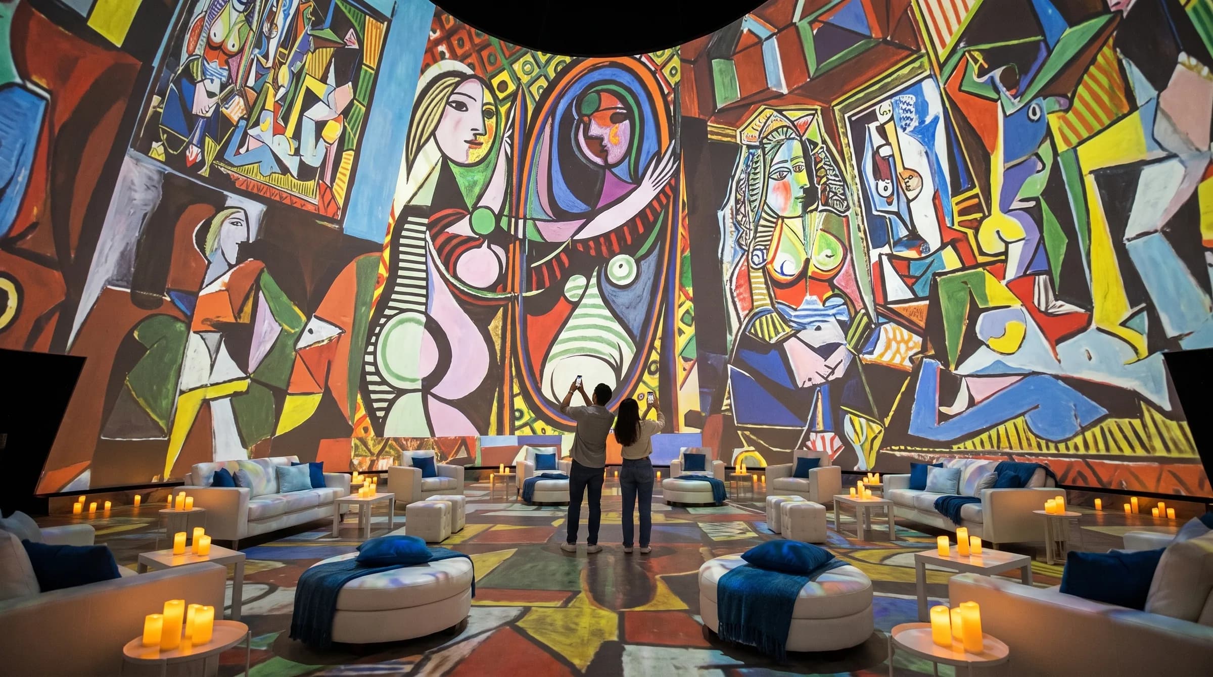 Projection dome interior with cubist artwork projected across the ceiling and lounge seating below